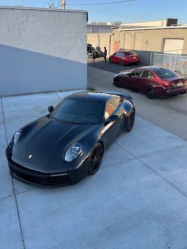 Black Porsche 911 parked outside the studio