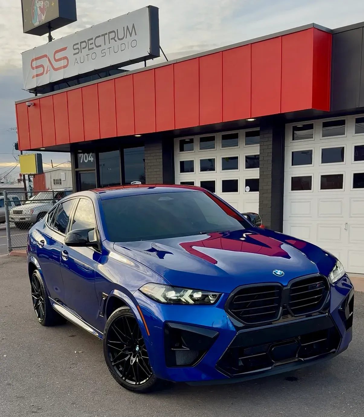 Blue BMW X6 M outside the Spectrum Auto Studio shop